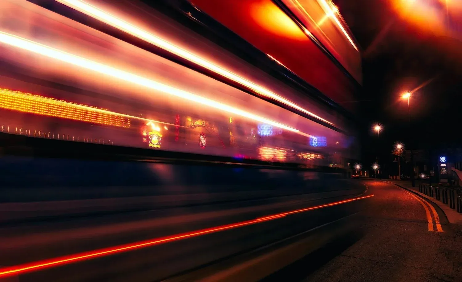 Long-exposure light trails along a road at night